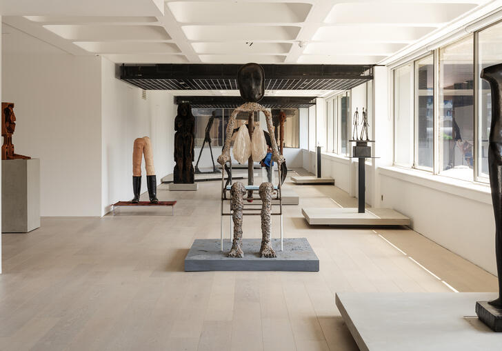 A shot of the gallery, showing sculptures by Giacometti and Huma Bhabha.